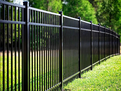 Black ornamental aluminum fence installed along a landscaped yard