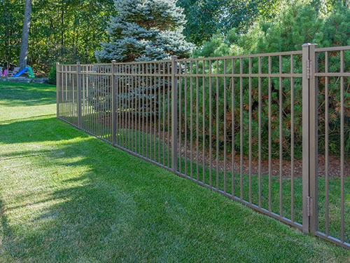 Black aluminum fence following a sloped yard