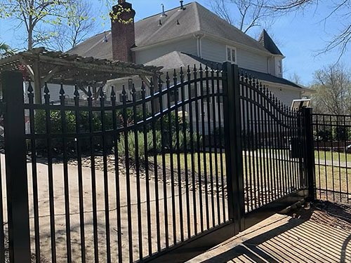 Automated electronic driveway gate at a residential entrance