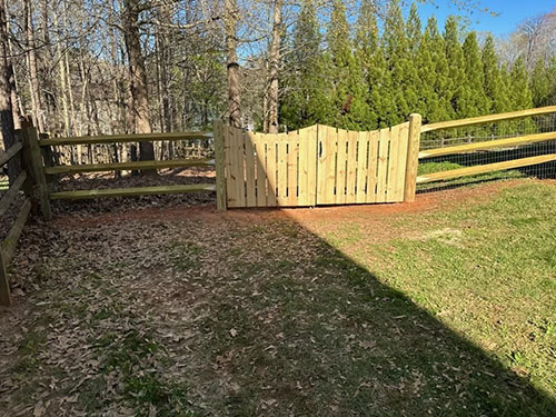 Two-rail split rail cedar fence along a rural property line