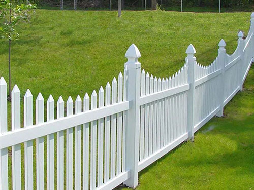White vinyl picket fence with a scalloped top